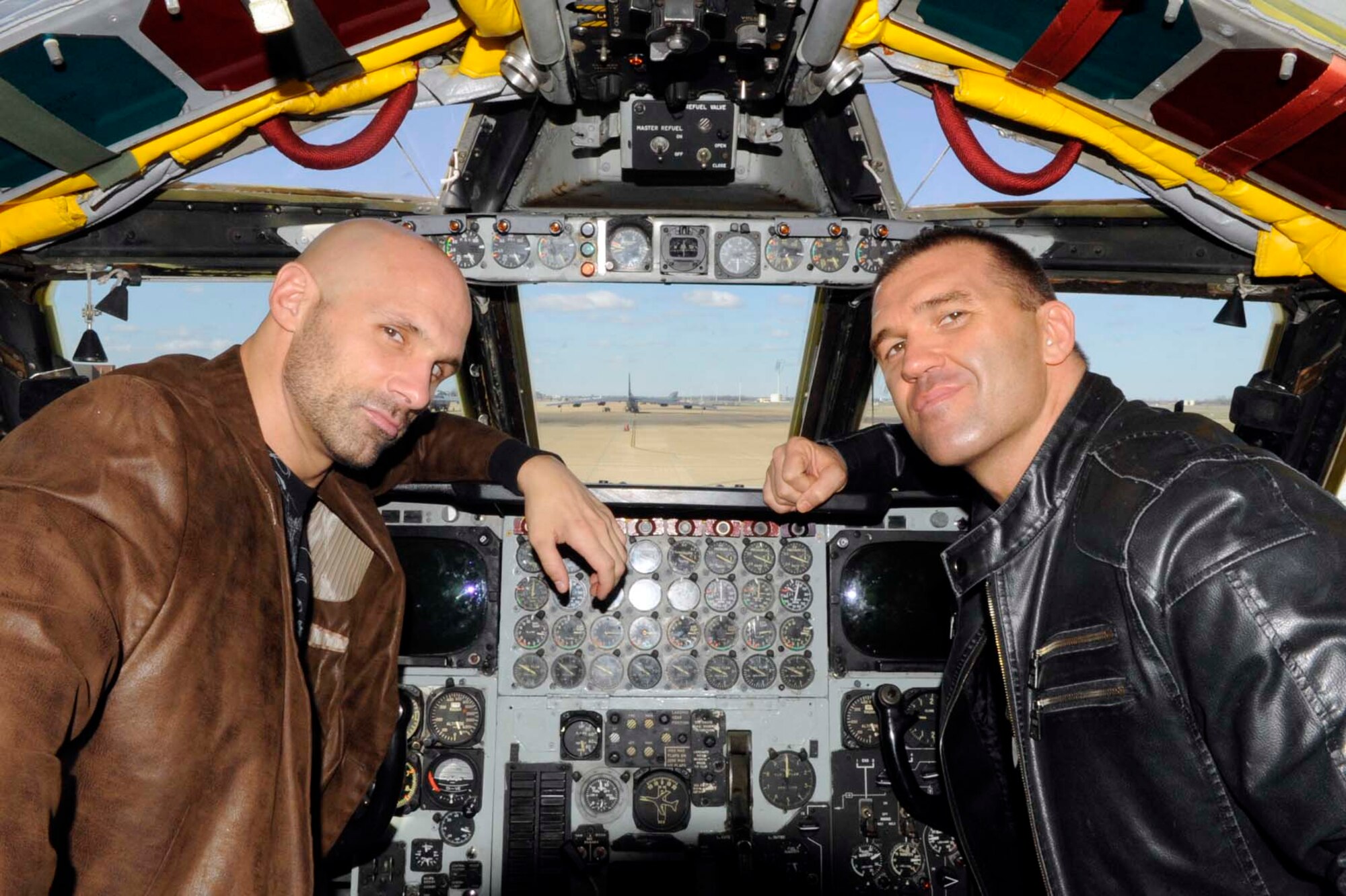 Total Nonstop Action wrestlers, Christopher Daniels and Frankie Kazarian pose for a photo in the cockpit of a B-52 Stratofortress at Barksdale Air Force Base, La., Feb. 8, 2013. The two wrestlers visited Barksdale for a meet and greet session with the troops at the Barksdale Exchange. They competed during the Road to Lock Down event at the Centurylink Center in Bossier City, La., Feb. 8. (U.S. Air Force photo by Master Sgt. Jeff Walston)