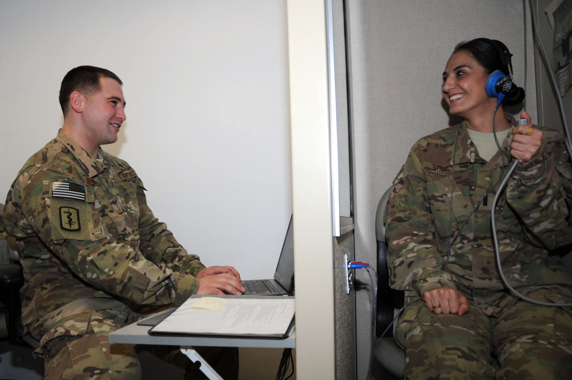 Senior Airman Derek Sanford, 455th Expeditionary Medical Operations Squadron public health technician, administers a hearing test to 1st Lt. Wajeeha Omar at the Craig Joint Theater Hospital on Bagram Airfield, Afghanistan, Feb. 7, 2013. Hearing tests are used to establish a baseline to be used for comparison later when personnel redeploy home. (U.S. Air Force photo/Staff Sgt. David Dobrydney)