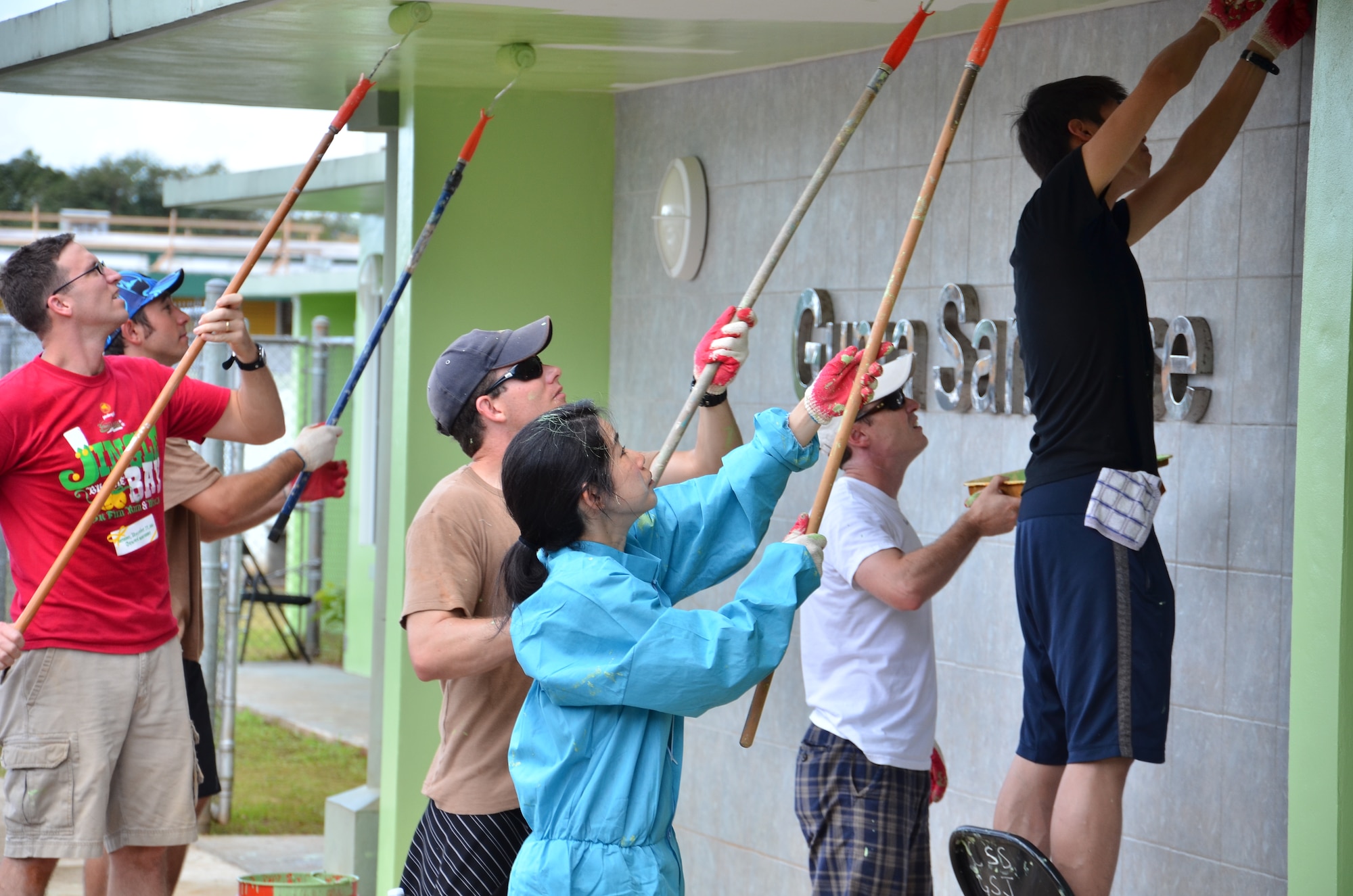 Personnel from the U.S. Air Force, Japan Air Self-Defense Force and Royal
Australian Air Force repaint the exterior walls and ceilings at the Guma' San Jose Homeless Shelter in Dededo, Guam on Feb. 9, 2013. More than 170 personnel from the three nations, all on Guam as participants in Cope North 13, volunteered at four local sites in Dededo, thanking the community for their support during the two-week exercise. (U.S. Air Force photo by Staff Sgt. Alexandre Montes/RELEASED) 
