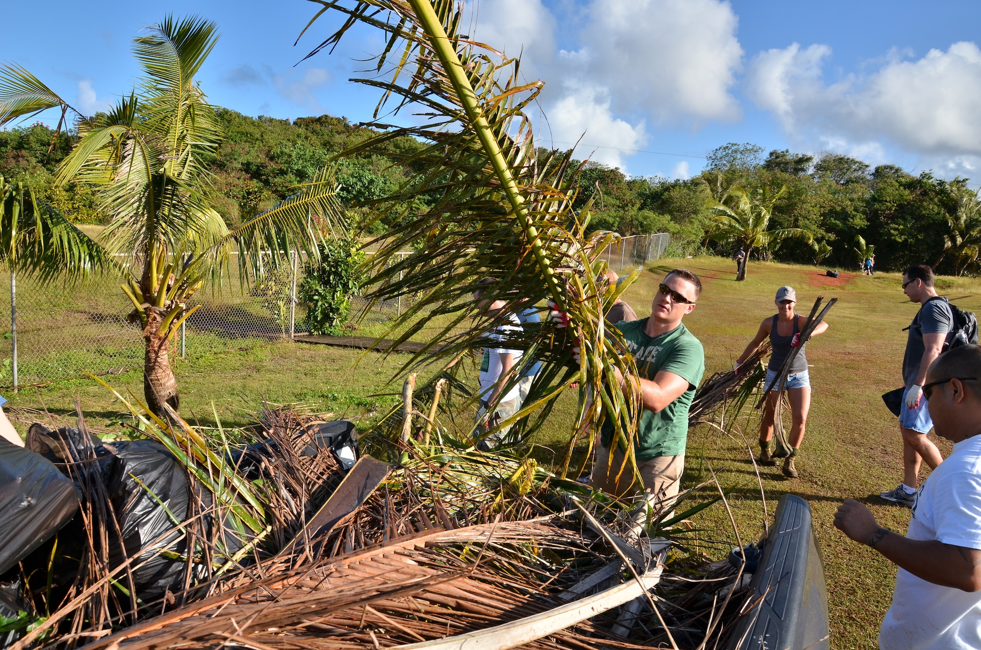 Personnel from the U.S. Air Force, Japan Air Self-Defense Force and Royal
Australian Air Force cut down and remove old shrubbery at the Wettengel Elementary School in Dededo, Guam on Feb. 9, 2013. More than 170 personnel from the three nations, all on Guam as participants in Cope North 13, volunteered at four local sites in Dededo, thanking the community for their support during the two-week
exercise. (U.S. Air Force photo by Staff Sgt. Alexandre Montes/RELEASED) 

