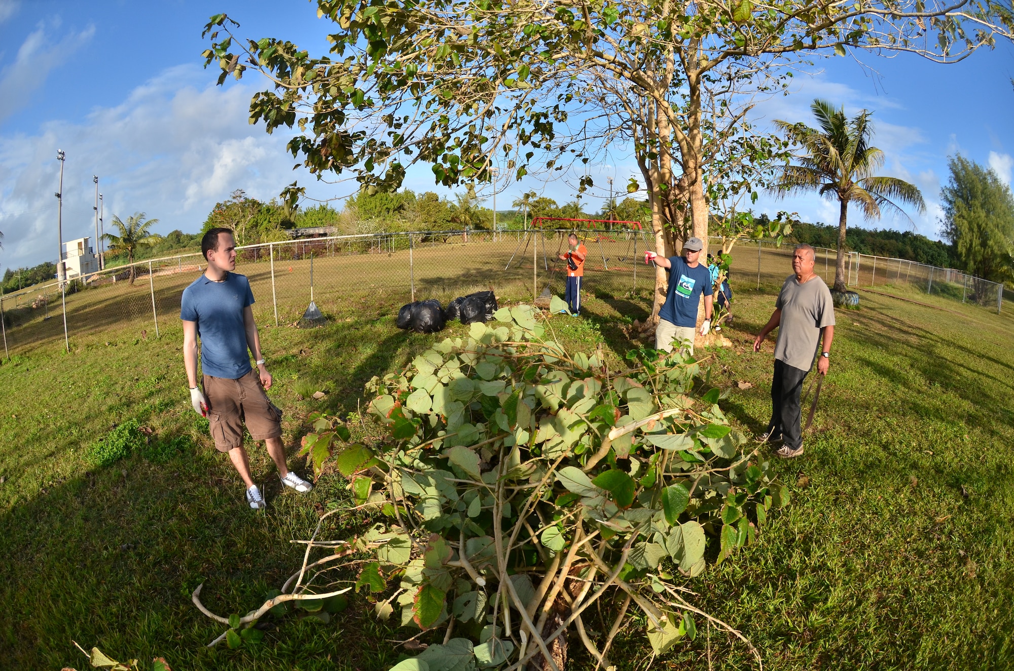 Personnel from the U.S. Air Force, Japan Air Self-Defense Force and Royal
Australian Air Force cut down and remove old shrubbery at the Wettengel Elementary School in Dededo, Guam on Feb. 9, 2013. More than 170 personnel from the three nations, all on Guam as participants in Cope North 13, volunteered at four local sites in Dededo, thanking the community for their support during the two-week
exercise. (U.S. Air Force photo by Staff Sgt. Alexandre Montes/RELEASED) 
