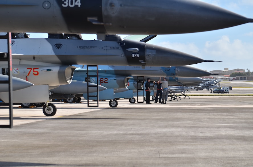 U.S. Air Force Airmen from the 18th Expeditionary Aircraft Maintenance Squadron, Kadena Air Base, Japan, wait for the U.S. Air Force F-16 pilots for the days training during Cope North 2013 at Andersen Air Force Base, Guam Feb 8. 2013. Cope North is an annual air combat tactics, humanitarian assistance and disaster relief exercise designed to increase the readiness and interoperability of the U.S. Air Force, Japan Air Self-Defense Force and Royal Australian Air Force. (U.S. Air Force photo by Staff Sgt. Alex Montes/RELEASED)