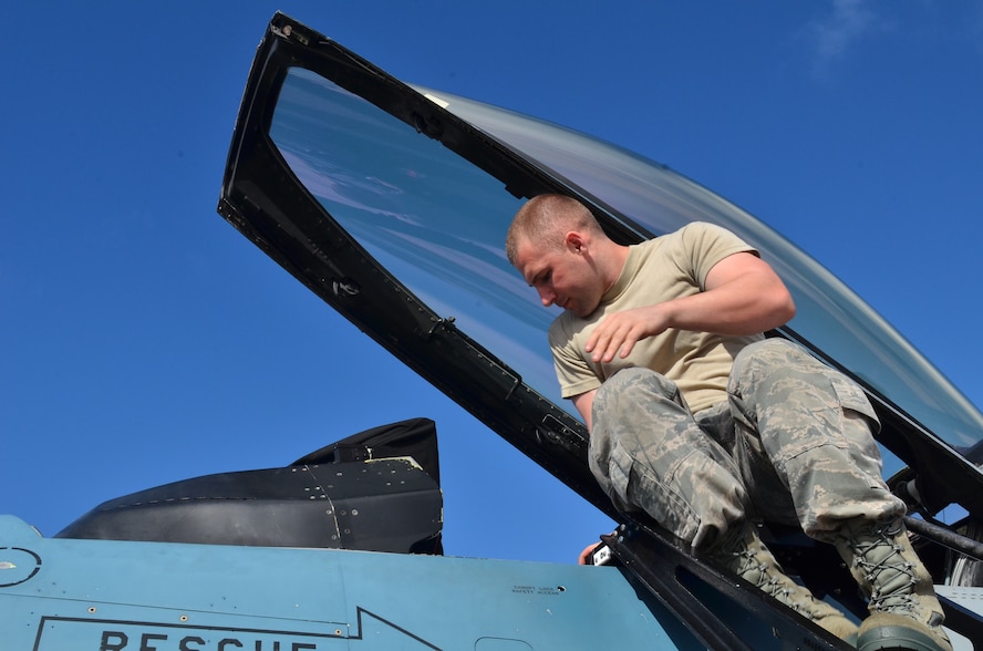 U.S. Air Force Airman 1st Class Anthony Tarnowski, 18th Expeditionary Aircraft Maintenance Squadron, Kadena Air Base, Japan, opens the canopy of a U.S. Air Force F-16 for inspection during Cope North 2013 at Andersen Air Force Base, Guam Feb 8. 2013. Cope North is an annual air combat tactics, humanitarian assistance and disaster relief exercise designed to increase the readiness and interoperability of the U.S. Air Force, Japan Air Self-Defense Force and Royal Australian Air Force. (U.S. Air Force photo by Staff Sgt. Alex Montes/RELEASED)