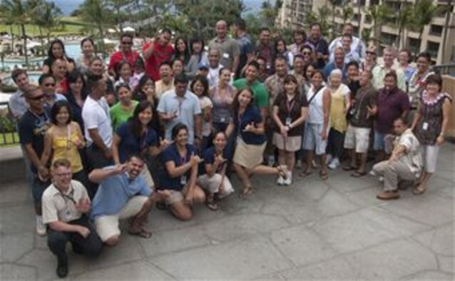 2nd Lt. Janet Hudson, center, poses with 624th Regional Support Group Reservists, their families, headquarters staff and guest briefers at a recent Yellow Ribbon event in Hawaii. The event was for 624th Civil Engineer Squadron Reservists who recently returned from deployment in Afghanistan in support of Operation Enduring Freedom, as well as their and their family members. (U.S. Air Force photo by Master Sgt. Daniel H. Nathaniel)