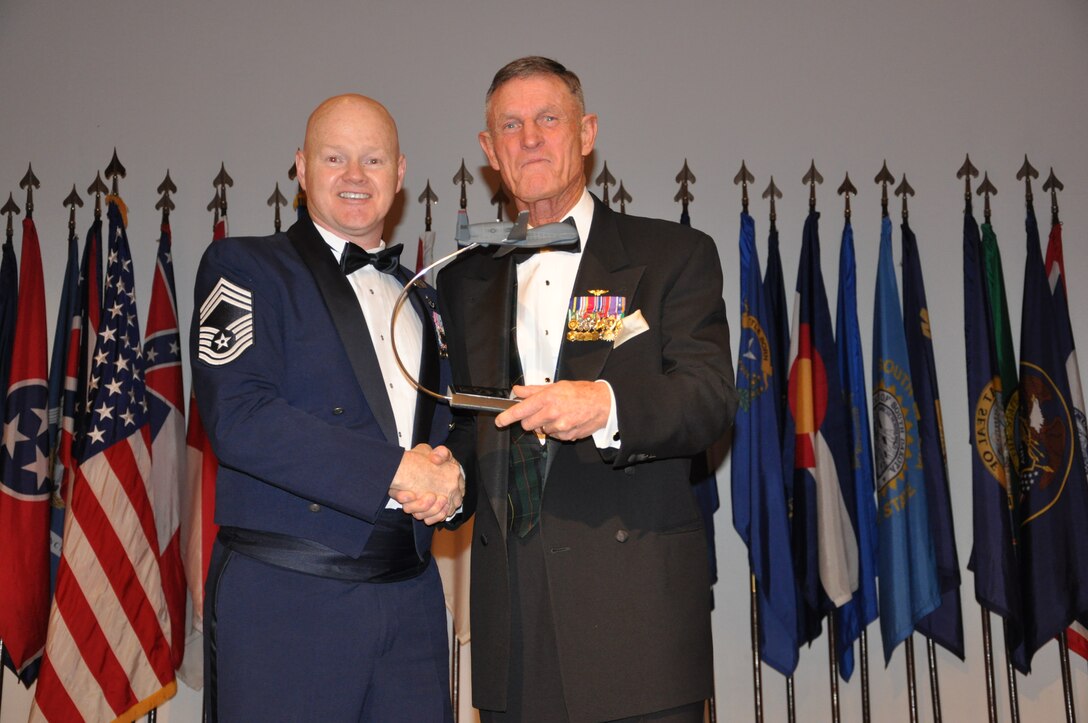 CMSgt Daniel Fisher presents retired United States Marine Corp General Richard Hearney with an RQ-4 Global Hawk model as a momento to thank him for speaking  at the 940th Wing's Award Banquet.  The 940th Wing held their first awards banquet Feb 9th during the UTA weekend.  (U.S. Air Force photo/SrA Adam Hamar)