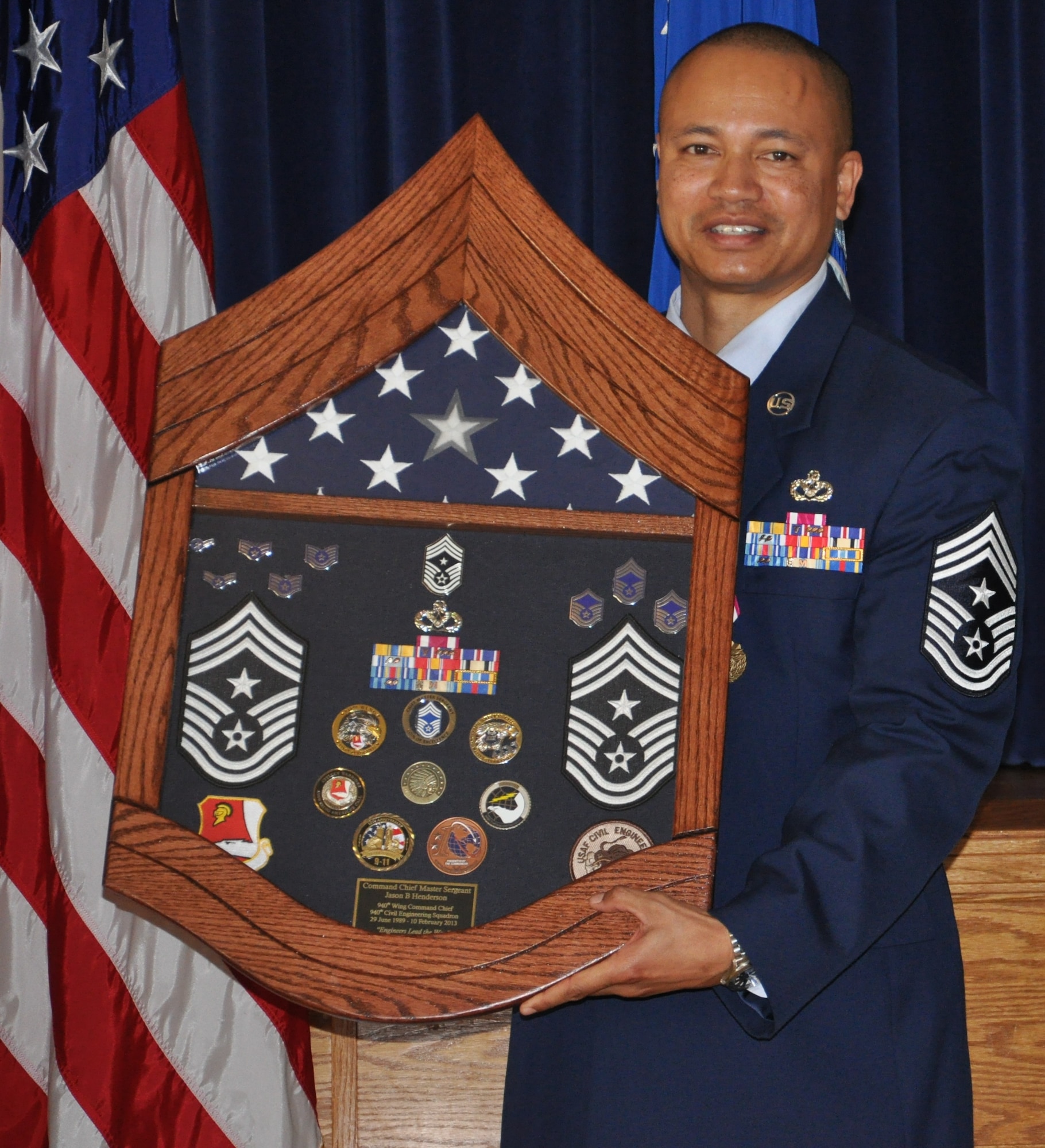 CMSgt Henderson recieves a shadow box containing momentos of his career during his retirement ceremony on Feb 10, during the UTA weekend.  Chief Henderson retires from the US Air Force after 24 years of service, four of which were as the command chief of the 940th Wing. (U.S. Air Force photo/SrA Adam Hamar)