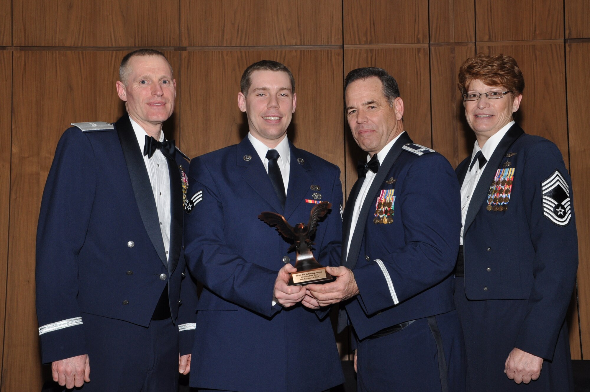 Senior Airman Raymond Carr, 931st Civil Engineering Squadron, (center) was named the Airman of the Year during the 931st Air Refueling Group 2nd Annual Award Banquet, Feb. 9. Carr is pictured with (from left to right) Brig. Gen. Kenneth D. Lewis, Director, Air Force Reserve Plans, Programs and Requirements; Col. Mark Larson, Commander, 931st ARG and Chief Master Sgt. Kathleen Lowman, Group Superintendent, 931 ARG. (Air Force photo by Master Sgt. Brannen Parrish)