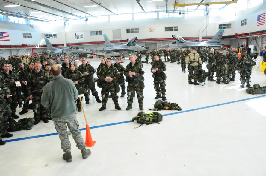 Staff Sgt. Ryan Dunlap, an emergency management technician from 127th Wing, speaks to 180th Fighter Wing Airmen about how to properly identify and cordon off an unexploded ordinance during Chemical, Biological, Radiological, Nuclear and Explosive training at the 180th Fighter Wing, Toledo, Ohio, February 9, 2013.  Airmen at the 180th were completing their annual CBRNE training in event of chemical warfare.  (U.S. Air Force photo by Staff Sergeant Amber Williams/Released)
