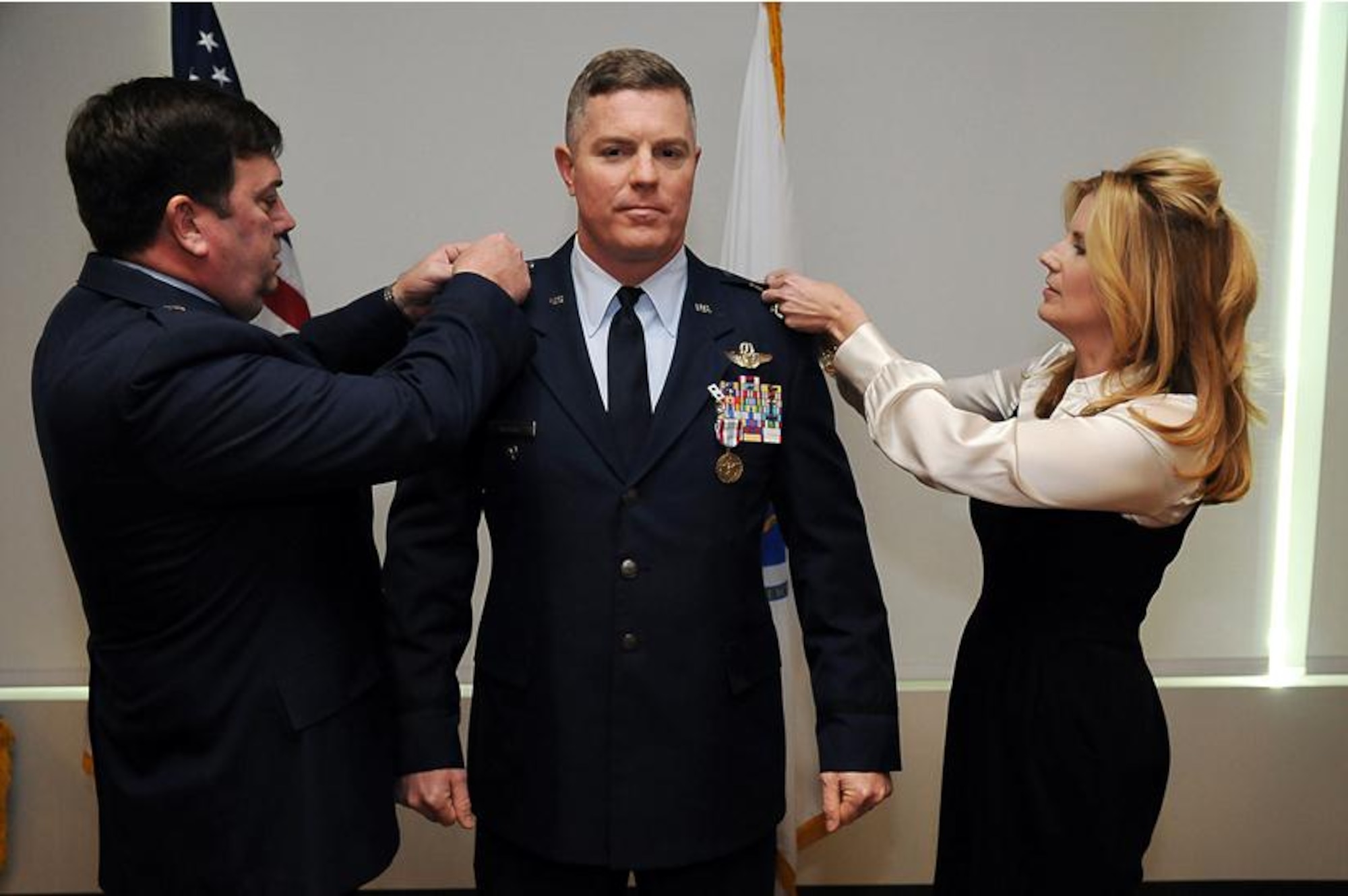 Brig. Gen. Gary Keefe, commander, Massachusetts Air National Guard, and Aprile Brooks pins the rank of Brigadier General on the uniform of Robert Brooks Jr., during a promotion ceremony at the Massachusetts National Guard's Joint Force Headquarters building, Hanscom Air Force Base, Bedford, Mass., Jan. 25, 2013. Brooks serves as the Assistant Adjutant General- Air, Massachusetts Air National Guard.