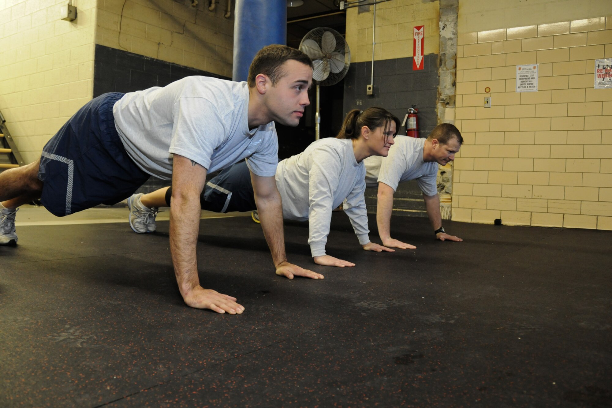 Staff Sgt. James Mack, Technical Sgt. Janice Stockett, and Staff Sgt. Eric McCulley, all members of the 127th Security Forces Squadron at Selfridge Air National Guard Base, Mich., recently earned Physical Training Leader Certification. They are seen in the 127th Wing’s fitness center, Feb. 10, 2013. The certification identifies them by the Air Force as qualified fitness training leaders for the 127th Wing.  (Air National Guard Photo by TSgt. Robert Hanet)