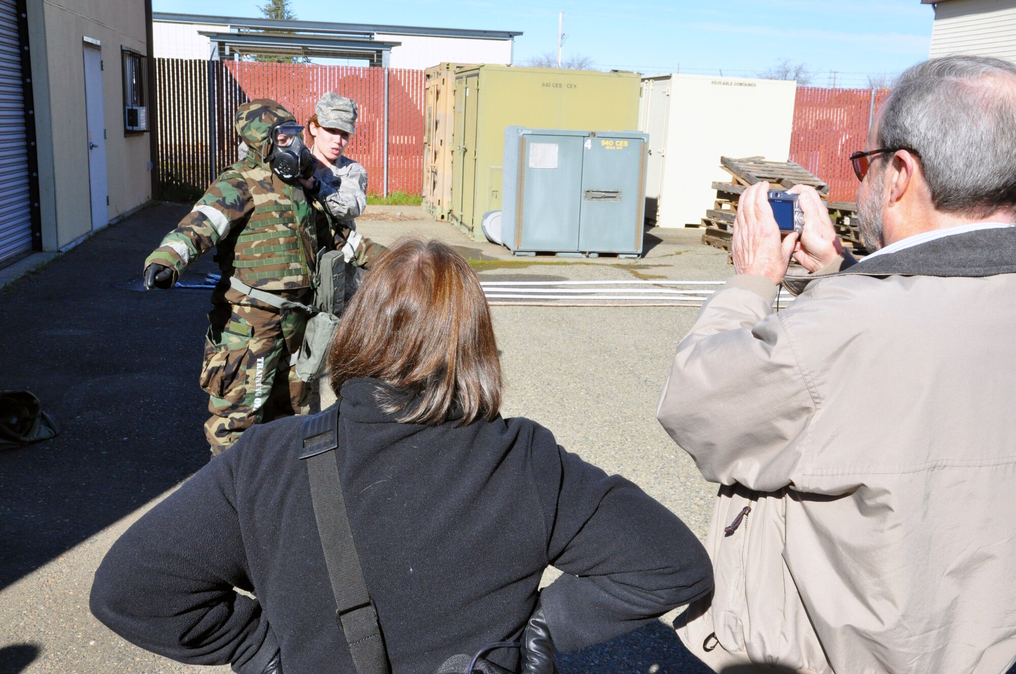 Members of the California Retired Teachers Association took pictures of a demonstration while on a tour held here during the Feburuary UTA. Tech Sgt. Stephanie Chan and Staff Sgt. Donna Gordan demonstrated the proper way to wear the JSLIST used to protect airmen in a chemical environment for a group of 28 educators from Northern California. (U.S. Air Force photo/SrA Adam Hamar)