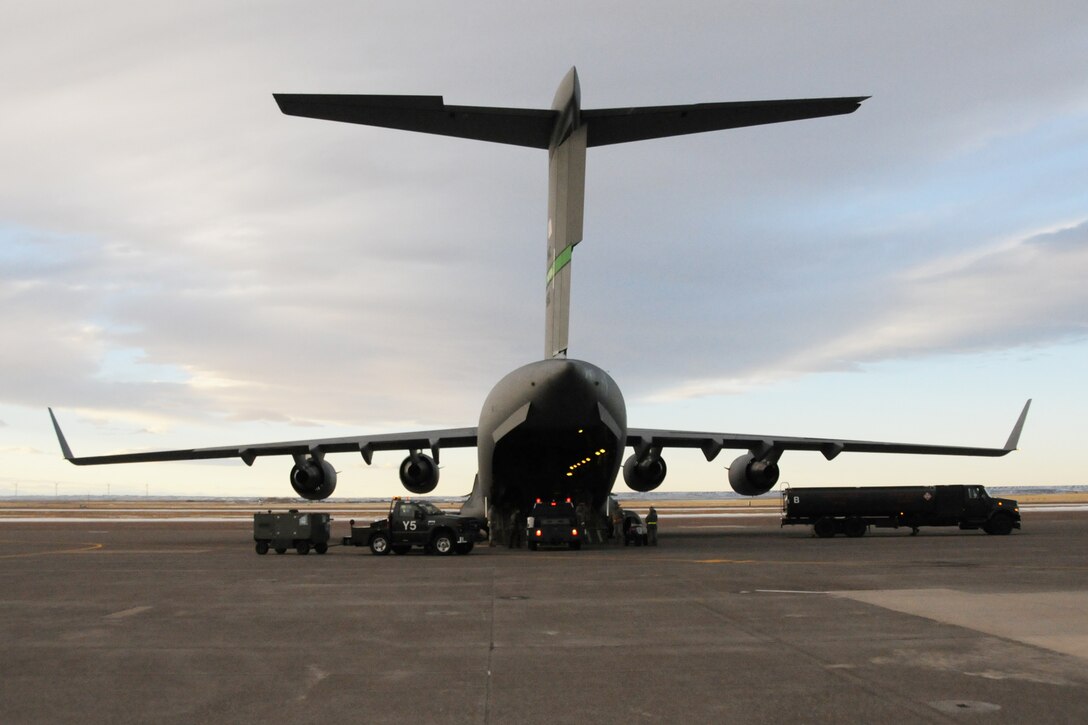 120th Fighter Wing Airmen prepare to load a C-17 Globemaster III aircraft with equipment at the Great Falls International Airport. The 120th Fighter Wing, Montana Air National Guard, is deploying people and equipment to Elmendorf Air Force Base, Alaska, to provide Aerospace Control Alert as part of Operation Noble Eagle. (National Guard photo/ Senior Master Sgt. Eric Peterson) (Released)