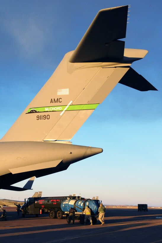 Airmen load a jet engine onto a C-17 Globemaster III aircraft at the Great Falls International Airport, January 18, 2013. The 120th Fighter Wing, Montana Air National Guard, is deploying people and equipment to Elmendorf Air Force Base, Alaska, to provide Aerospace Control Alert as part of Operation Noble Eagle. (National Guard photo/ Senior Master Sgt. Eric Peterson) (Released))