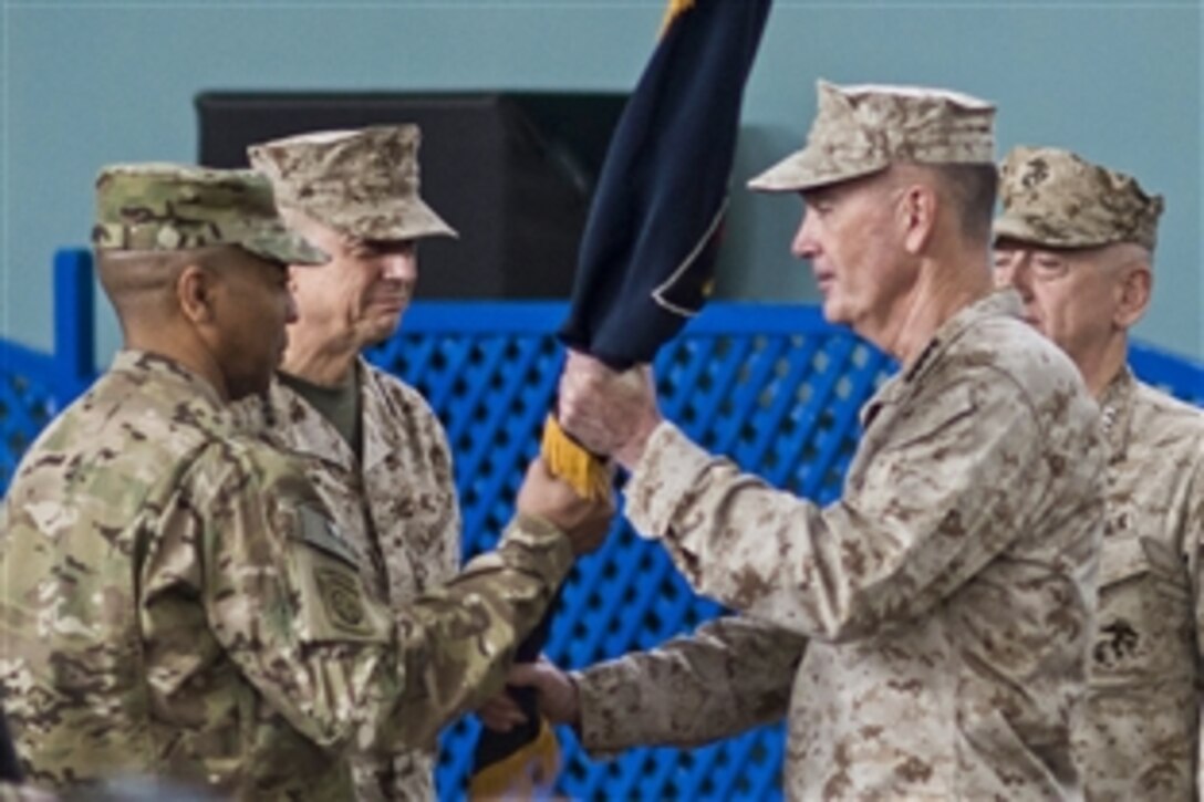 U.S. Marine Corps Gen. Joseph F. Dunford Jr., incoming commander of U.S. and NATO forces in Afghanistan, and U.S. Marine Corps Gen. John R. Allen, outgoing commander, participate in a change-of-command ceremony at the International Security Assistance Force headquarters in Kabul, Afghanistan, Feb. 10, 2013. 