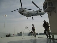 Italian service members secure the deck of a ship as part of a Visit, Board, Search and Seizure capabilities demonstration along with United Arab Emirates, Bahrain and U.S. military counterparts during fast rope techniques practice in the Port of Zayed area in Abu Dhadi, UAE as part of Exercise Leading Edge 13, Jan. 31, 2013. LE 13 is a multinational supported exercise designed to strengthen tactical proficiencies in critical mission areas of Weapons of Mass Destruction interdiction. (U.S. Marine Corps photo by MSgt. Salvatore Cardella)


