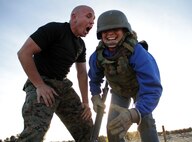 Drill instructor Sgt. Matthew Lee motivates a teacher from Recruiting Station Kansas City who volunteered to tackle the bayonet assault course during an educators workshop Jan. 29. For additional imagery from the event, visit www.facebook.com/rstwincities.