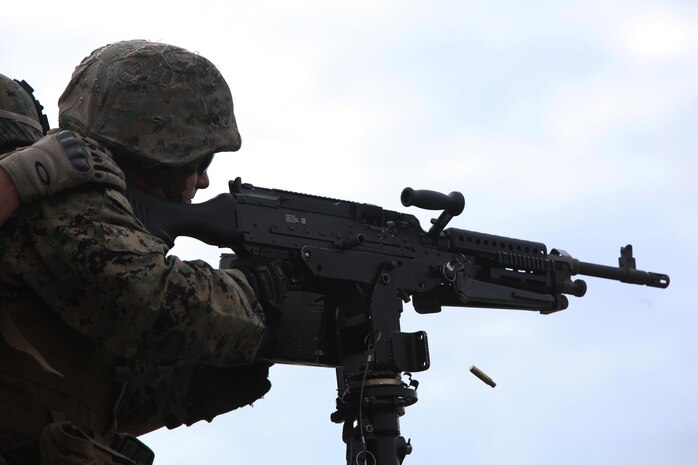 A Marine with Bridge Company, 8th Engineer Support Battalion, 2nd Marine Logistics Group fires an M-240 machine gun mounted on a boat as part of a training operation aboard Camp Lejeune, N.C., Jan. 30, 2013. Bridge Co. had not fired machine guns from boats more than a decade.