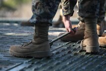 A Marine with Bridge Company, 8th Engineer Support Battalion, 2nd Marine Logistics Group prepares to lift a segment of a medium girder bridge during an exercise aboard Camp Lejeune, N.C., Jan. 29, 2013. Bridge Co. assembled bridges as part of a training exercise designed to improve unit efficiency.