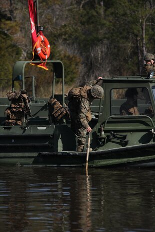 A Marine with Bridge Company, 8th Engineer Support Battalion, 2nd Marine Logistics Group checks water depth as a precaution against beaching during a bridging operation aboard Camp Lejeune, N.C., Jan. 29, 2013. Bridge Co. practiced assembling and disassembling improved ribbon bridges and medium girder bridges to improve unit readiness.