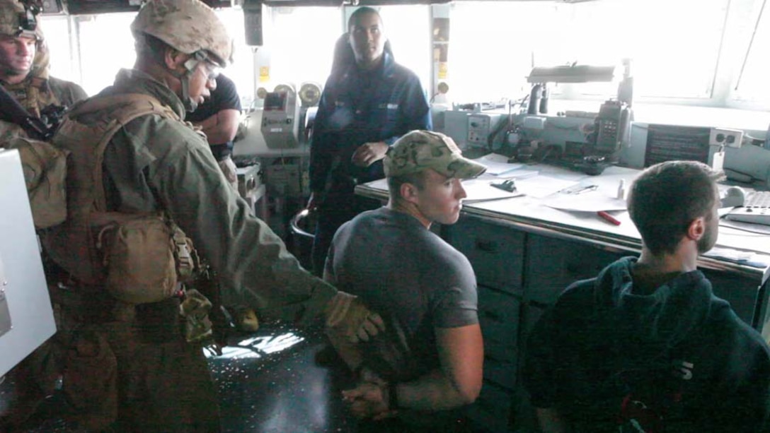 U.S. Marines with Maritime Raid Force, 15th Marine Expeditionary Unit, search event role players while practicing visit, board, search and seizure procedures during Exercise Leading Edge 13 aboard USS Winston S. Churchill (DDG 81), Feb. 5. The exercise is a multinational and interagency supported exercise designed to develop and refine weapons integration capabilities among partnering nations including suspect maritime material inspections, seizure and disposition.  The 15th MEU is deployed as part of the Peleliu Amphibious Ready Group as a U.S. Central Command theatre reserve force, providing support for maritime security operations and theatre security cooperation efforts in the U.S. 5th Fleet area of responsibility. (U.S. Marine Corps photo by Cpl. Bobby J. Gonzalez/Released)