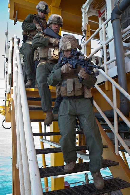 (Front to back) U.S. Marine Corps Cpl. Adrian Edeyaoch, Lance Cpl. Eloy Magana and Hospital Corpsman 3rd Class Drew Brown with Maritime Raid Force, 15th Marine Expeditionary Unit, conduct gas and oil platform seizure training during Exercise Leading Edge 13, Feb. 6. The exercise is a multinational and interagency supported exercise designed to develop and refine weapons integration capabilities among partnering nations including suspect maritime material inspections, seizure and disposition.  The 15th MEU is deployed as part of the Peleliu Amphibious Ready Group as a U.S. Central Command theatre reserve force, providing support for maritime security operations and theatre security cooperation efforts in the U.S. 5th fleet are of responsibility. (U.S. Marine Corps photo by Cpl. Bobby J. Gonzalez/Released)