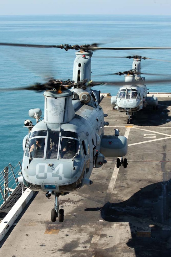 Two U.S. Marine Corps CH-46E Sea Knight helicopters from Marine Medium Helicopter Squadron 364 (Rein), 15th Marine Expeditionary Unit, take off from the flight deck of USS Green Bay (LPD 20) to provide aerial support for the Maritime Raid Force, 15th MEU, during gas and oil platform seizure training during Exercise Leading Edge 13, Feb. 7. The exercise is a multinational and interagency supported exercise designed to develop and refine weapons integration capabilities among partnering nations including suspect maritime material inspections, seizure and disposition.  The 15th MEU is deployed as part of the Peleliu Amphibious Ready Group as a U.S. Central Command theatre reserve force, providing support for maritime security operations and theatre security cooperation efforts in the U.S. 5th Fleet area of responsibility.(U.S. Marine Corps photo by Cpl. Danny L. Shaffer II/Released)