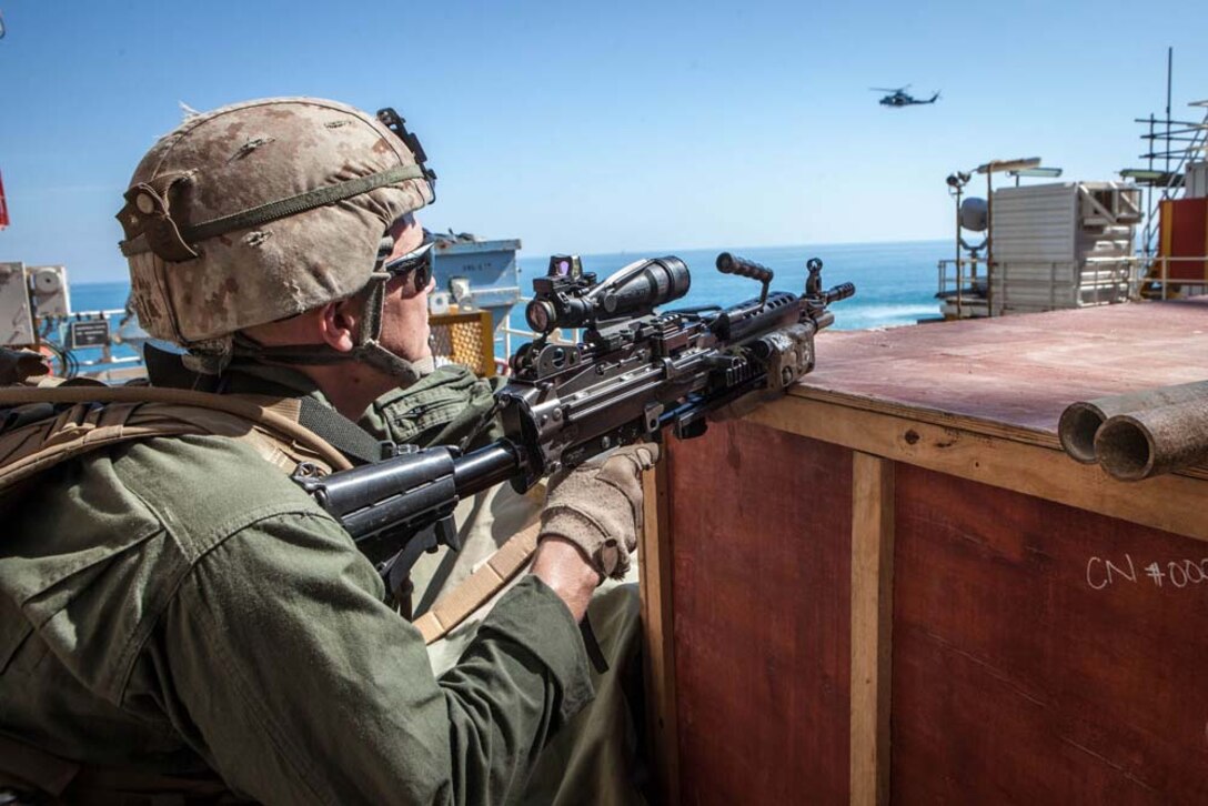 U.S. Marine Corps Lance Cpl. Joshua Blong, Maritime Raid Force, 15th Marine Expeditionary Unit, scans the area for threats during gas and oil platform seizure training during Exercise Leading Edge 13, Feb. 7. The exercise is a multinational and interagency supported exercise designed to develop and refine weapons integration capabilities among partnering nations including suspect maritime material inspections, seizure and disposition.  The 15th MEU is deployed as part of the Peleliu Amphibious Ready Group as a U.S. Central Command theatre reserve force, providing support for maritime security operations and theatre security cooperation efforts in the U.S. 5th Fleet area of responsibility. (U.S. Marine Corps photo by Cpl. Bobby J. Gonzalez/Released)