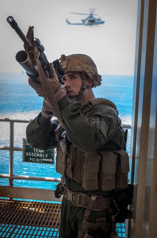 U.S. Marine Corps Pfc. Dustyn Osbourne, Maritime Raid Force, 15th Marine Expeditionary Unit, scans the area for threats during gas and oil platform seizure training during Exercise Leading Edge 13, Feb. 7. The exercise is a multinational and interagency supported exercise designed to develop and refine weapons integration capabilities among partnering nations including suspect maritime material inspections, seizure and disposition.  The 15th MEU is deployed as part of the Peleliu Amphibious Ready Group as a U.S. Central Command theatre reserve force, providing support for maritime security operations and theatre security cooperation efforts in the U.S. 5th Fleet area of responsibility. (U.S. Marine Corps photo by Cpl. Bobby J. Gonzalez/Released)