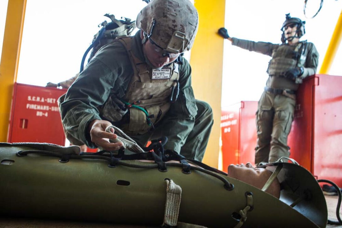 U.S. Marine Corps Lance Cpl. Jonathan Nguyen, Maritime Raid Force, 15th Marine Expeditionary Unit, attends to a mock casualty during gas and oil platform seizure training during Exercise Leading Edge 13, Feb. 7. The exercise is a multinational and interagency supported exercise designed to develop and refine weapons integration capabilities among partnering nations including suspect maritime material inspections, seizure and disposition. The 15th MEU is deployed as part of the Peleliu Amphibious Ready Group as a U.S. Central Command theatre reserve force, providing support for maritime security operations and theatre security cooperation efforts in the U.S. 5th Fleet area of responsibility. (U.S. Marine Corps photo by Cpl. Bobby J. Gonzalez/Released)