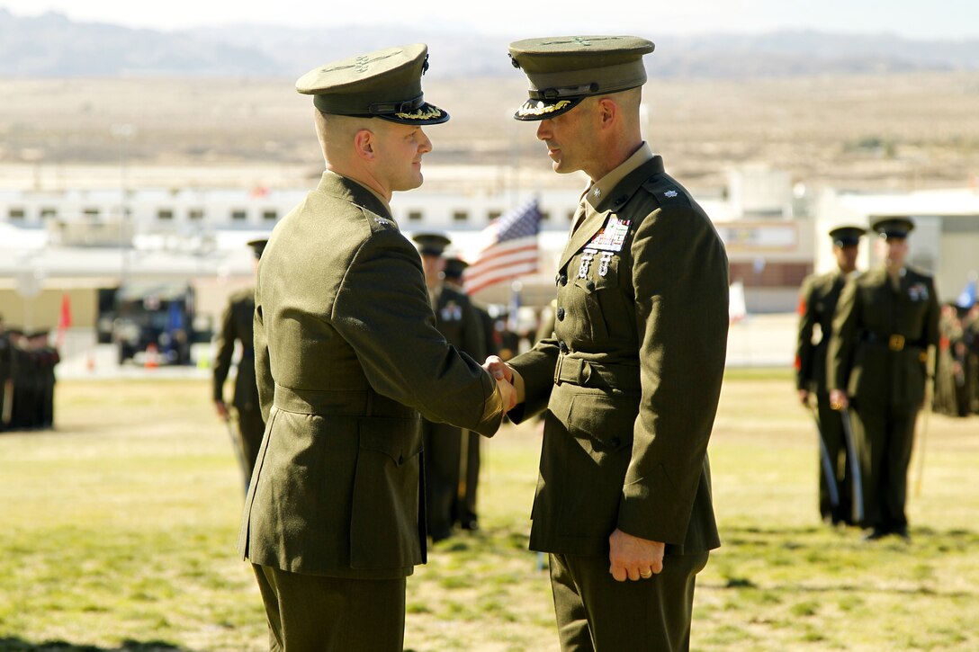 Lt. Col. Seth E. Yost shakes hands with Lt. Col. David P. Bradney during 1st Battalion, 7th Marine Regiment’s change of command ceremony Jan. 31, 2013.