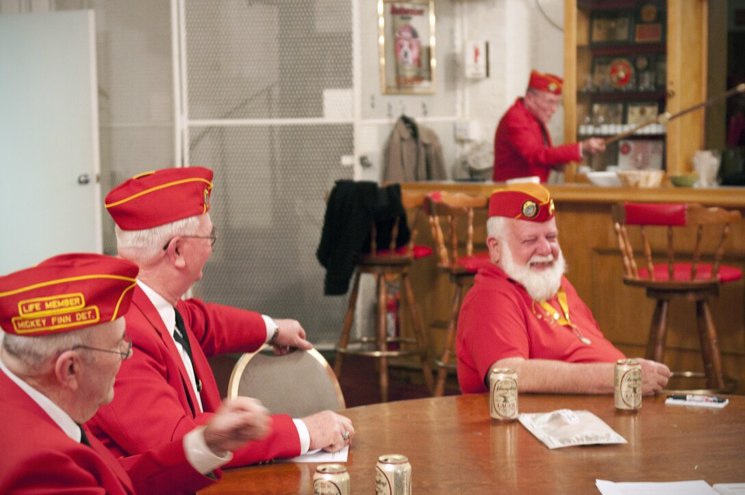 Members of the Marine Corps League Detachment 565 share a laugh during the monthly meeting, Nov. 16, 2012. The meetings take place in an old firehouse built in 1901 they bought from the City of Baltimore more than 20 years ago. During monthly meetings, members talk about awards and funding for their support programs such as Food for Needy, Raven’s Roost, and the Francis Scott Key Elementary/Middle School scholarship program. (U.S. Marine Corps photo by Cpl. Marcin Platek/Released) 