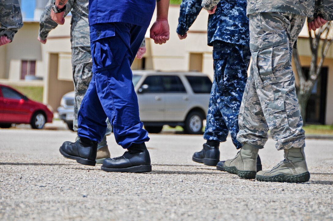 Students from the Airman Leadership School march in step during a marching evaluation at Andersen Air Force Base, Guam, Feb. 8, 2013. This is the first class in Andersen ALS history with a Coast Guard student, and the second class with Navy participation. (U.S. Air Force photo by Airman 1st Class Marianique Santos/Released)