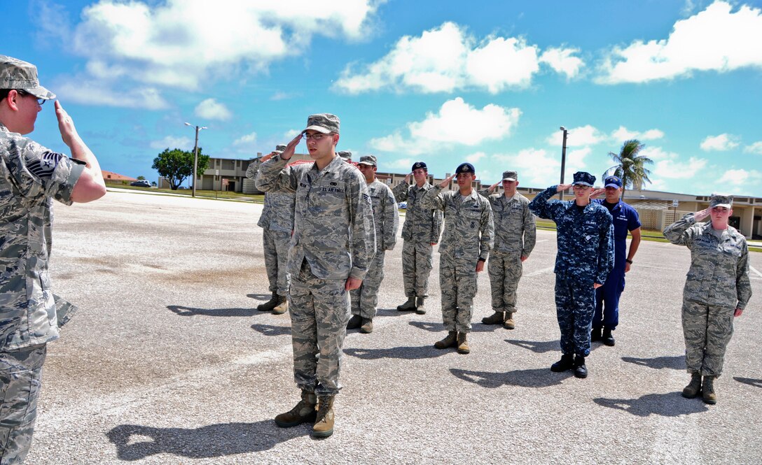 Students from the Airman Leadership School salute their instructor to demonstrate proper reporting procedures during an open ranks and marching evaluation at Andersen Air Force Base, Guam, Feb. 8, 2013. ALS prepares and trains future NCOs for increased responsibilities and is one of many professional military education courses in the Air Force. (U.S. Air Force photo by Airman 1st Class Marianique Santos/Released)