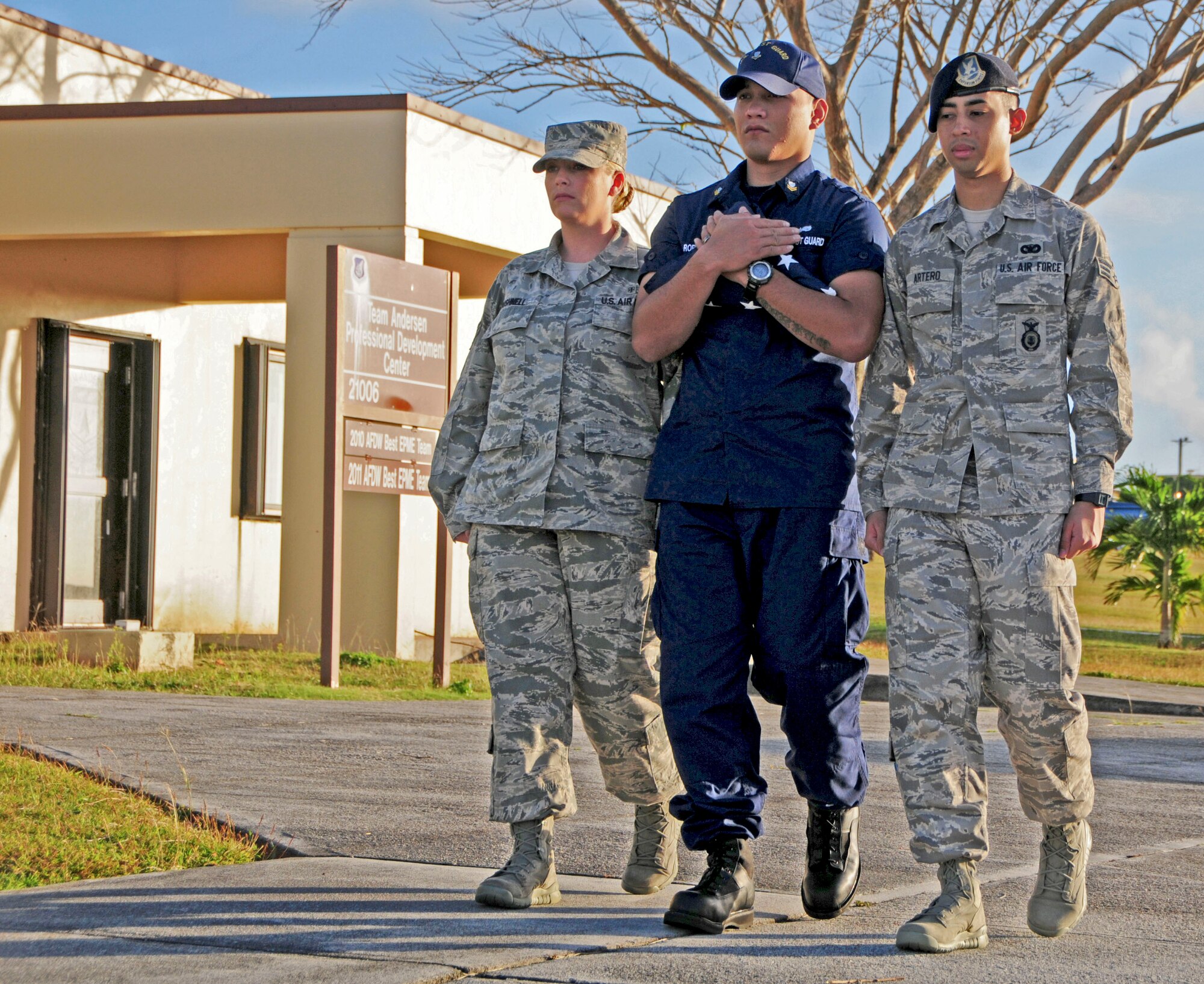 Students from the Airman Leadership School walk the flag toward the pole during the flag-raising ceremony on Andersen Air Force Base, Guam, Feb. 7, 2013. This is the first class in Andersen ALS history with a Coast Guard student, and the second class with Navy participation. (U.S. Air Force photo by Airman 1st Class Marianique Santos/Released)