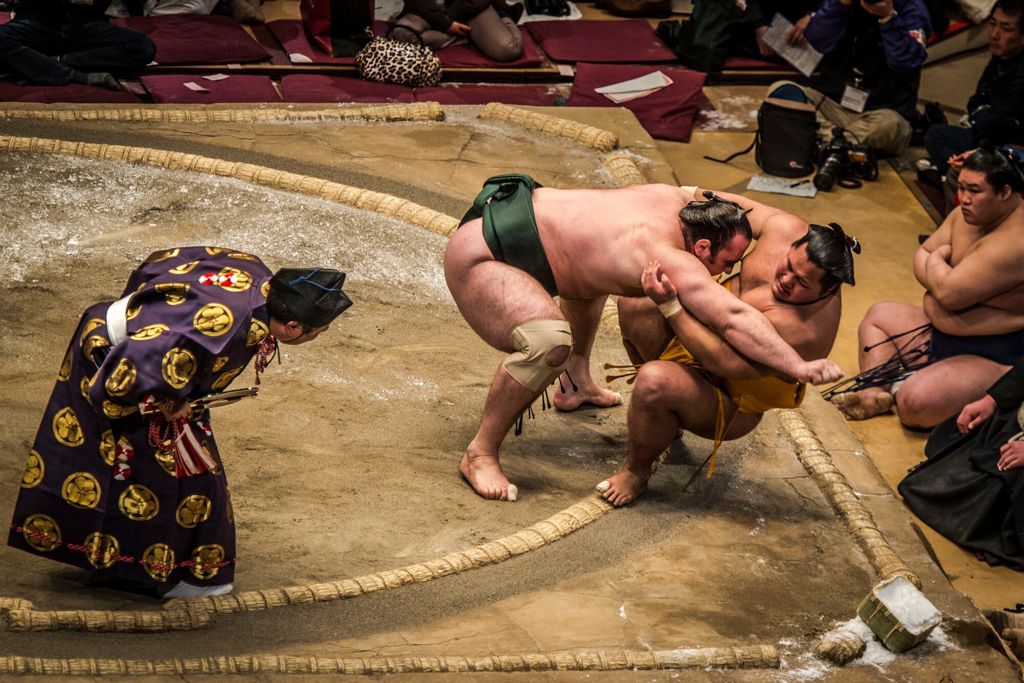 YOKOTA AIR BASE,Japan -- A Sumo wrestler pushes his opponent out of the ring during the Grand Sumo Tournament at the Ryogoku Kokugikan Sumo Hall in Tokyo, Feb. 10, 2013. During a Sumo match, two wrestlers, or rikishi, attempt to force one another out of a circular ring, or dohyo. A tournament features dozens of rikishi competing in an elimination-style roster to determine the champion. (U.S. Air Force photo by Capt. Raymond Geoffroy)