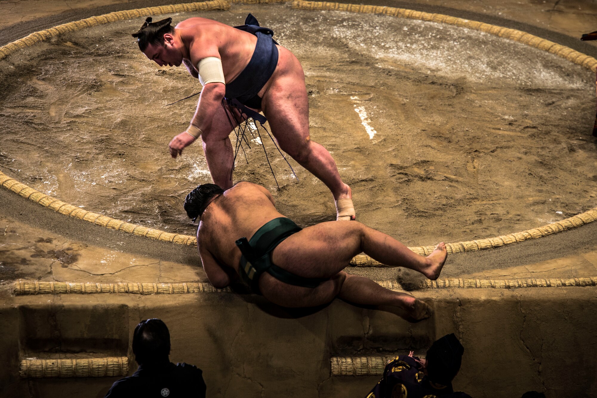 YOKOTA AIR BASE,Japan -- A Sumo wrestler throws his opponent out of the ring during the Grand Sumo Tournament at the Ryogoku Kokugikan Sumo Hall in Tokyo, Feb. 10, 2013. Thanks to the Yokota Air Base’s Information, Tickets and Travel office, Yokota Airmen had the unique opportunity to experience Sumo first-hand. (U.S. Air Force photo by Capt. Raymond Geoffroy)