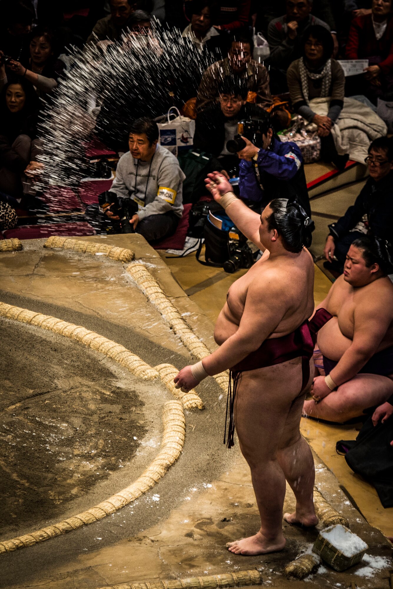 YOKOTA AIR BASE,Japan -- A Sumo wrestler throws salt into the ring as part of a purification ritual before a bout during the Grand Sumo Tournament at the Ryogoku Kokugikan Sumo Hall in Tokyo, Feb. 10, 2013. Sumo involves several ritual elements developed over a history of centuries. (U.S. Air Force photo by Capt. Raymond Geoffroy)