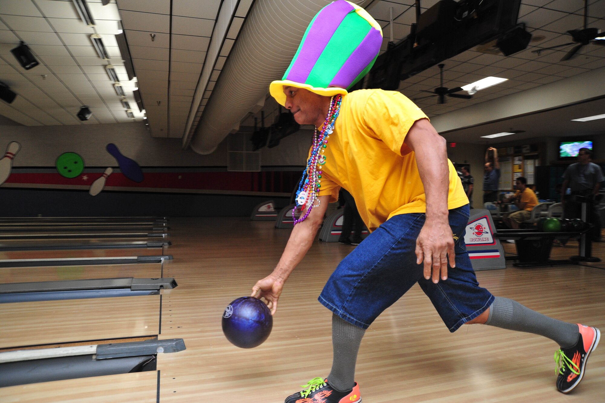 Maj. Dennis Walker, 403rd Aircraft Maintenance Squadron maintenance officer, steps out in true Mardi Gras fashion at the 403rd Wing’s first Mardi Gras Bowl-a-palooza held at Keesler Air Force Base, Miss., Feb. 9, 2013. The 403rd Wing Human Resource Development Council, Wingman’s Council and Rising VI organized the event to promote celebrating the spirit of Mardi Gras in a fun, safe environment. (U.S. Air Force photo/Tech. Sgt. Ryan Labadens)