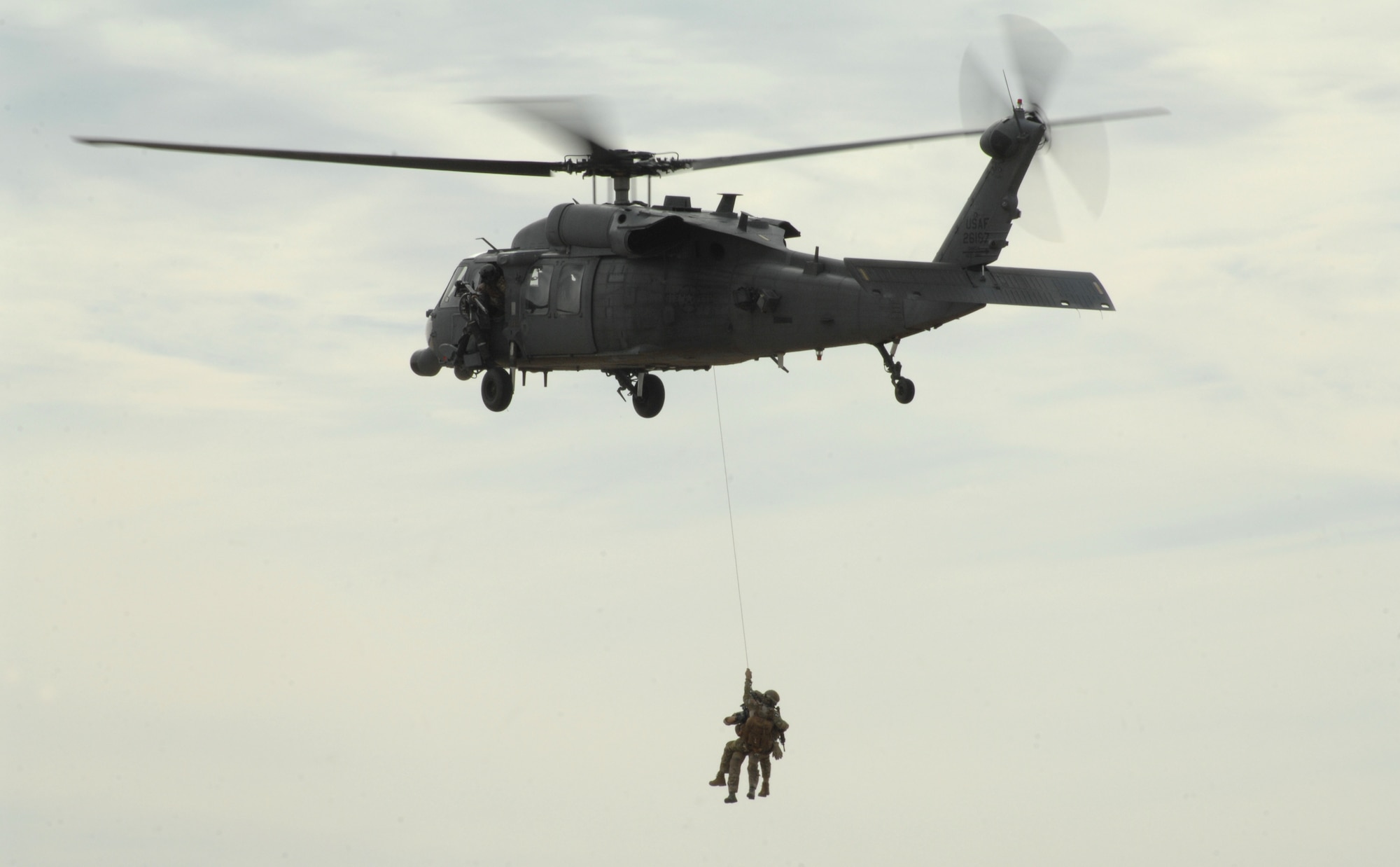 Pararescuemen from Davis-Monthan Air Force Base, Ariz., perform a combat search and rescue demonstration for members of the media, DM-50, military affairs committee and base populous here Feb. 8. Attendees were also invited to watch a pre-screening of the first episode of National Geographic’s “Inside Combat Rescue at the base theater. (U.S. Air Force photo by Senior Airman Michael Washburn/Released)