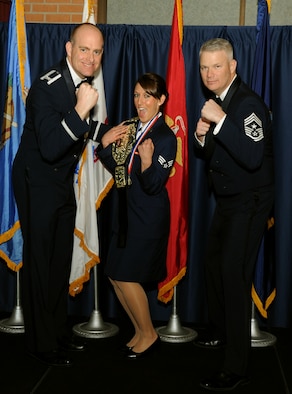 Senior Airman Alisha Jones, center, receives recognition as the 71st Flying Training Wing 2012 Annual Award winner in the Volunteer of the Year category from Col. Darren James, left, the 71st FTW commander, and Chief Master Sgt. Mark Aman, the 71st FTW command chief. Seventeen military, civilian and contract partners were recognized during the ceremony held Feb. 7 at Vance Air Force Base, Okla. (U.S. Air Force photo/ Staff Sgt. James Bolinger)
