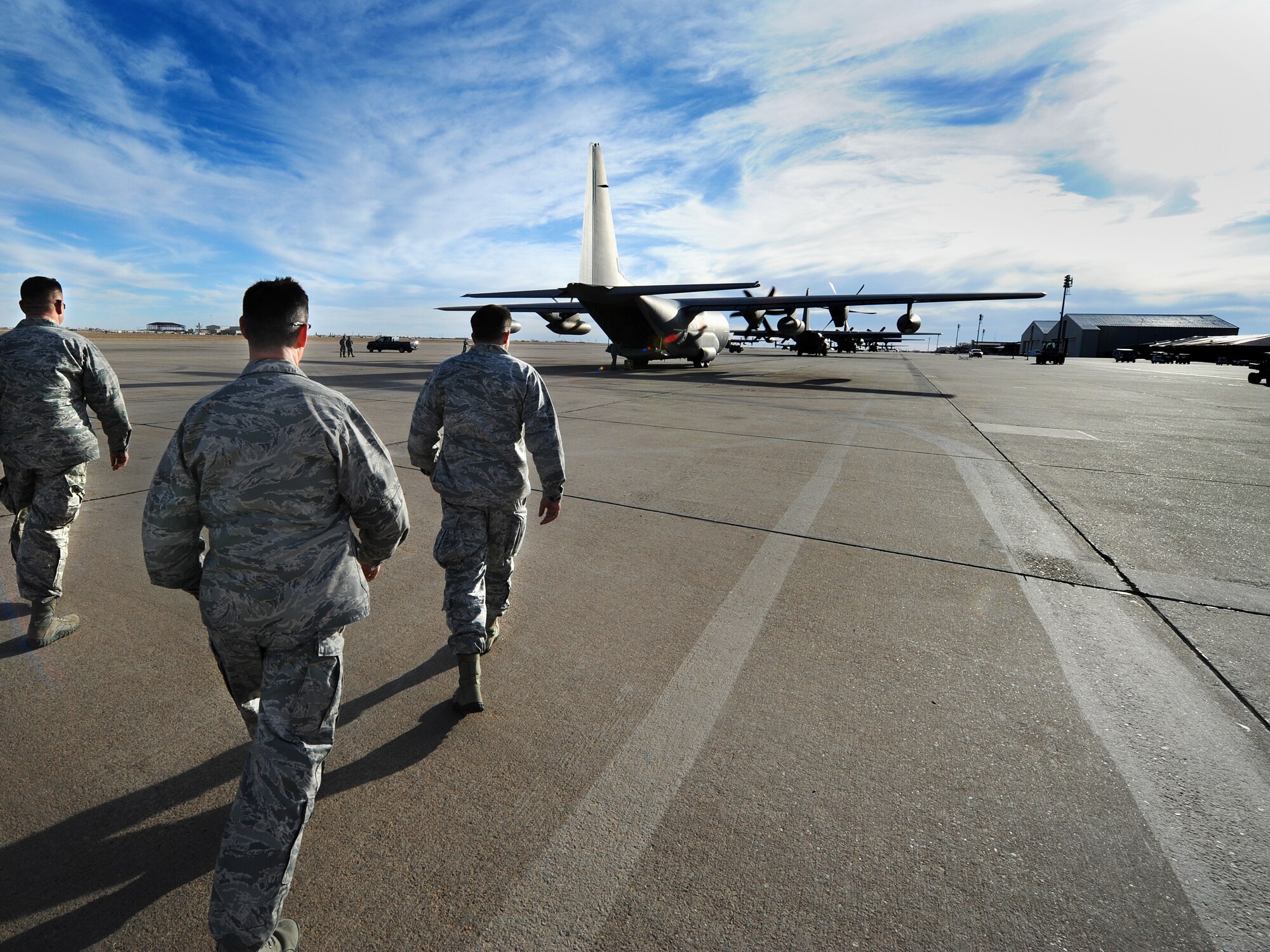 The 27th Special Operations Wing leadership walks toward an MC-130J Commando II to greet redeployers during Operation Homecoming at Cannon Air Force Base, N.M., Feb. 6, 2013.  Operation Homecoming is a monthly event held to welcome Airmen back from deployment.  (U.S. Air Force photo/Senior Airman Jette Carr)