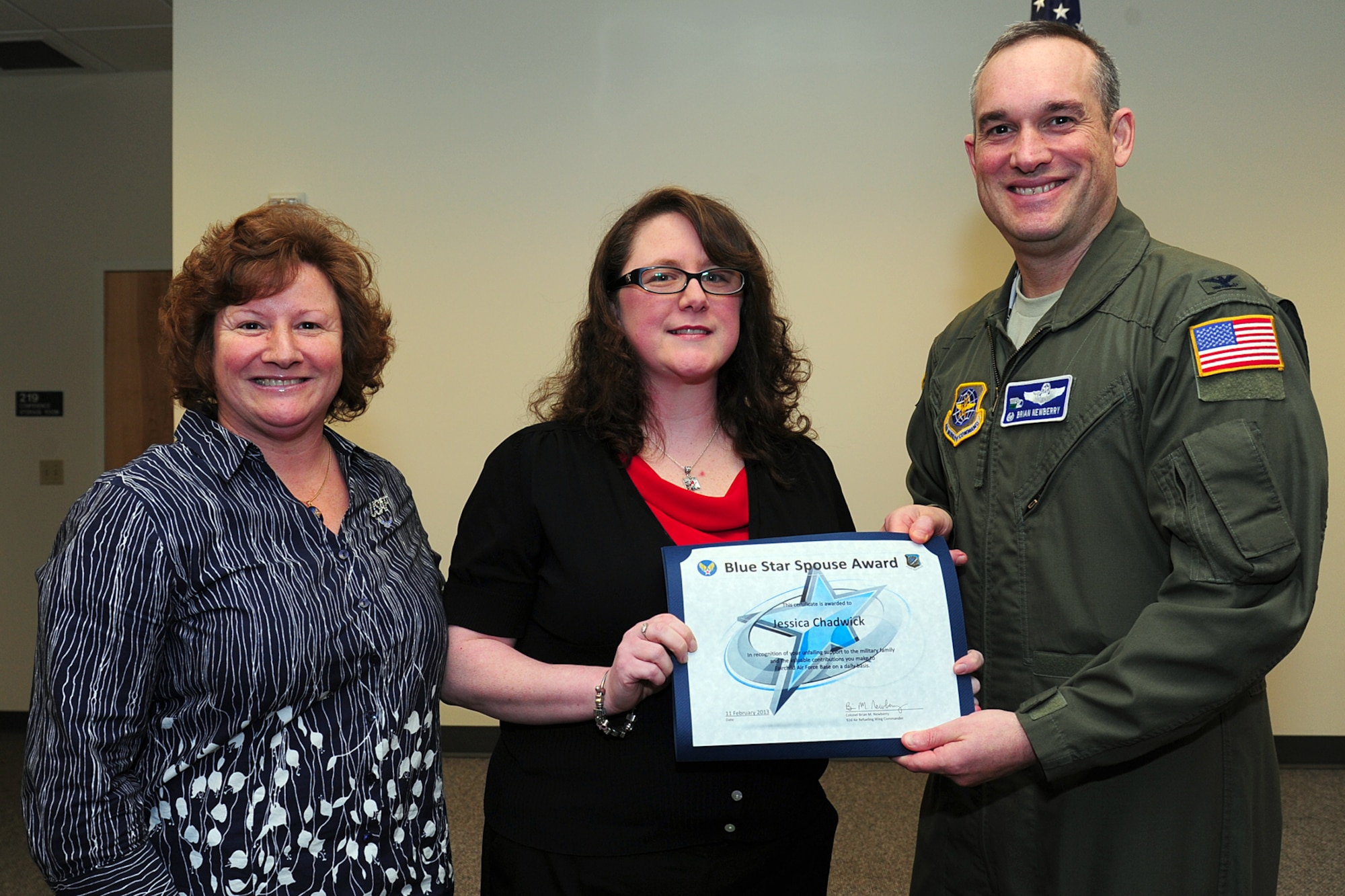 Col. Newberry, 92nd Air Refueling Wing commander, and his wife, Jill, presents the Blue Star Spouse Award to Jessica Chadwick, Feb. 11, 2013. The award is presented to Fairchild spouses for their commitment to excellence and support to the Fairchild family. Chadwick is an active member of the enlisted spouses club. Anyone interested in nominating someone for the Blue Star Spouse Award should contact their squadron commander. (U.S. Air Force photo by Airman 1st Class Janelle Patiño)