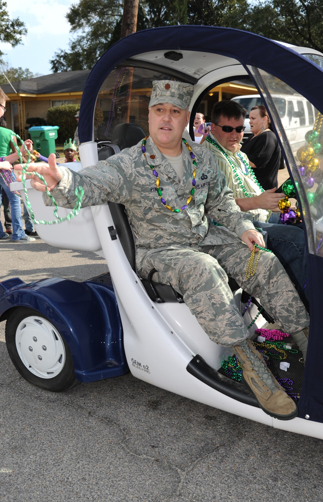 Maj. John Ponton, 81st Force Support Squadron commander, throws beads during the Jeff Davis Elementary School Mardi Gras Parade in Biloxi, Miss., Feb. 8, 2013. The Keesler Honor Guard marched and Col. Mark Vivians, 81st Mission Support Group commander, and his wife, Lt. Col. Jileene Vivians, 2nd Air Force director of staff, served as grand marshals for the event.  (U.S. Air Force photo by Kemberly Groue)