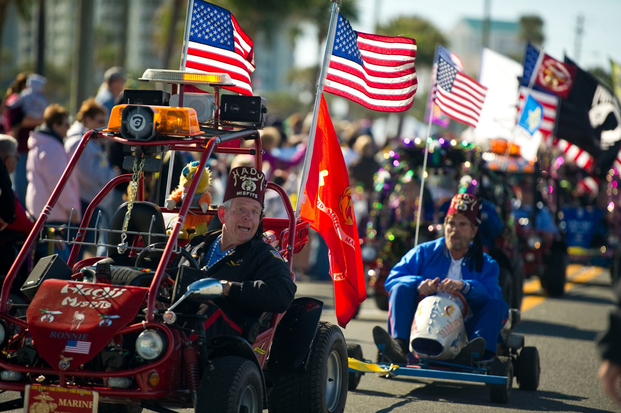 Member of the Hadji Misfits, a local group of the Shriners, ride carts bearing flags along a parade route during a mardi gras parade at Navarre Beach, Fla., Feb. 2, 2013. Several entries competed for winning best entry in the parade. (U.S. Air Force photo / Tech. Sgt. Vanessa Valentine)