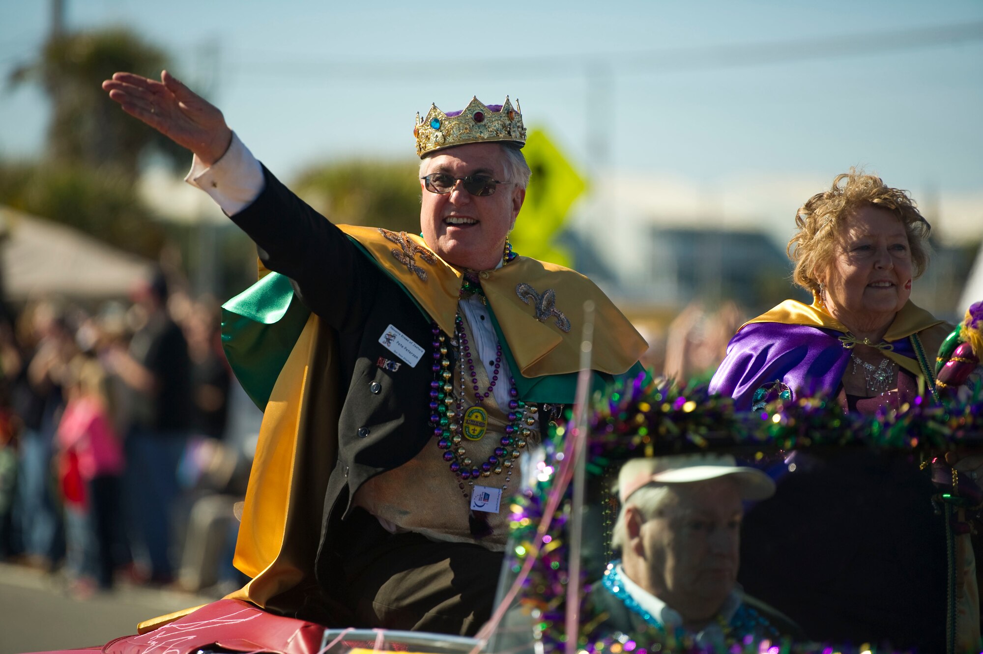 Pete Peterzen, king of the 2013 Navarre Krewe of Jesters, waves while riding on a float in a mardi gras parade at Navarre Beach, Fla., Feb. 2, 2013. More than 25,000 citizens attended the parade and its festivities. (U.S. Air Force photo / Tech. Sgt. Vanessa Valentine)