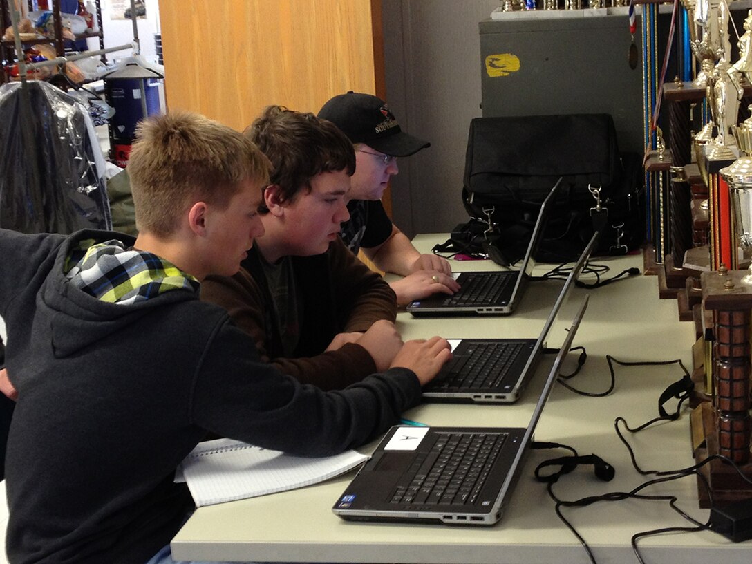 From left, Coffee County High School Air Force Junior Reserve Officer Training Corps cadets Sam West, Dawson Carlton and Steve Messick use laptops provided by Arnold AFB’s STEM program to train for an upcoming CyberPatriot V competition. (Photo provided)