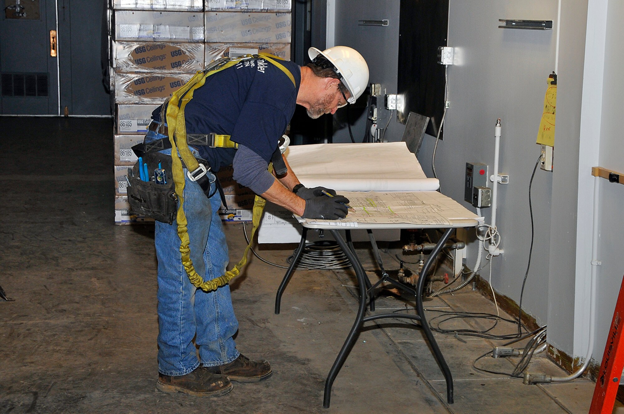 Robert Flanders with Tri-State Sprinkler, Corp., is installing a new sprinkler system as part of an ongoing renovation project at AEDC’s Precisions Measurement Equipment Laboratory.  (Photo by Jacqueline Cowan)