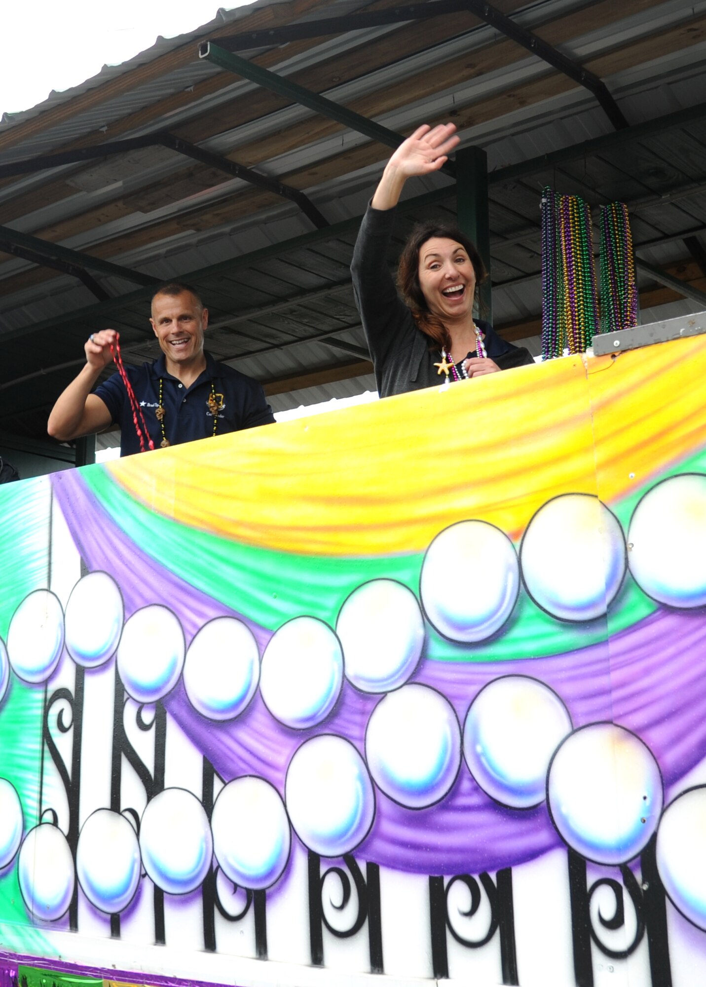 Brig. Gen. Bradley Spacy, 81st Training Wing commander, and his wife, Lisa, wave to the crowd from a float during the North Bay Area Mardi Gras Parade in D’Iberville, Miss., Feb. 10, 2013.  The Keesler Air Force Base Honor Guard and Airmen carrying the 50 state flags followed by the 81st Training Group drum and bugle corps also participated in the festivities.  (U.S. Air Force photo by Kemberly Groue)