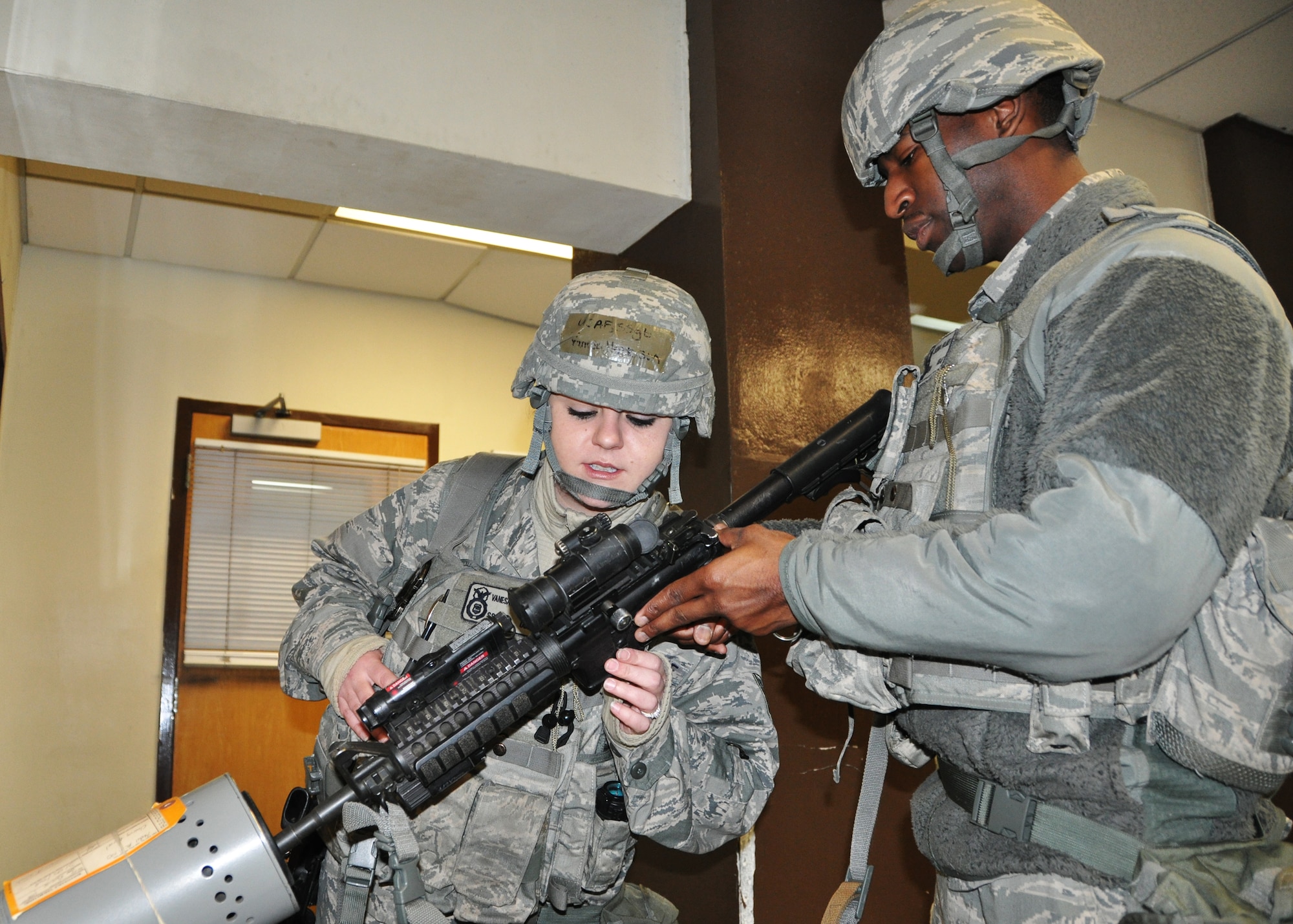 Staff Sgt. Joshua Holmes, 51st Security Forces Squadron member, clears an M-4 carbine under the supervision of Staff Sgt. Vanesa Henderson, 51st SFS area supervisor, during operational readiness exercise Beverly Bulldog Feb.11, 2013. The exercise  highlights Osan Airmen’s ability to position, employ and sustain forces, and showcase operational readiness. (U.S. Air Force photo/Senior Airman Kristina Overton)