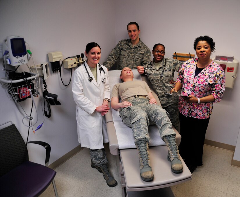 Capt. Brea Whitehair, 779th Medical Group family medicine physician; Airman 1st Class Andrew Noonan, 779 MDG family health technician; Airman 1st Class Jazmine Thomas, 779 MDG medical technician; and Nwatu Uloma, 779 MDG family health clinic registered nurse, gather around Airman 1st Class Audra Smith for a photo in a patient care room at Malcolm Grow Medical Clinic on Feb.7, 2013 on Joint Base Andrews, Md. The 779 MDG received recognition from the Patient-Centered Medical Home 2011 Program for their expertise in quality patient care. (U.S. Air Force photo/ Airman 1st Class Erin O’Shea)          